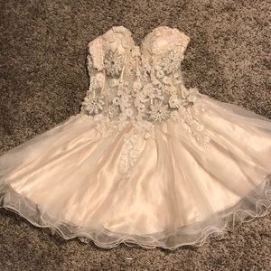 Ivory semi formal dress with detailed beading.